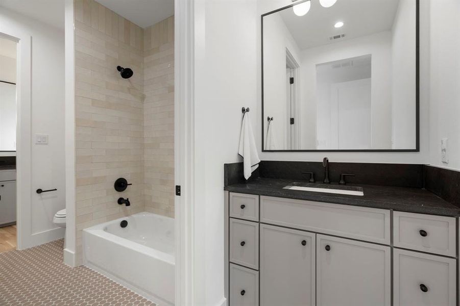 Bathroom featuring vanity, washtub / shower combination, and recessed lighting Bathroom featuring vanity, washtub / shower combination, and recessed lighting