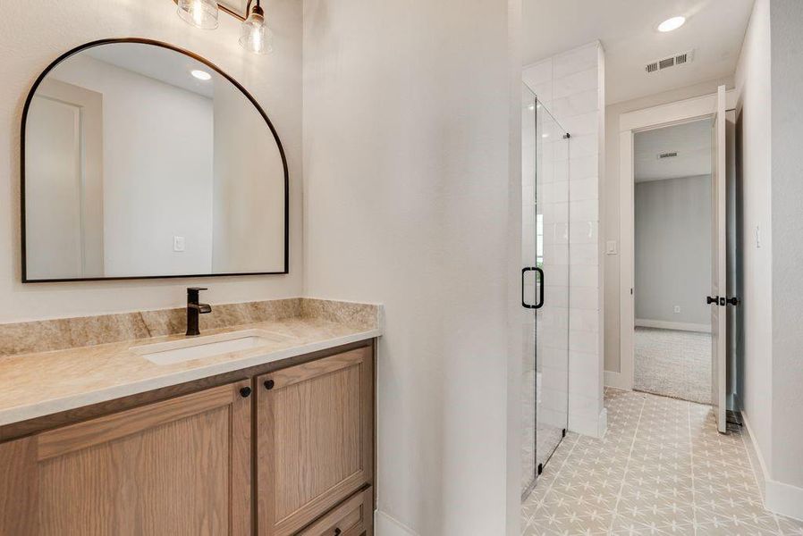 Full bathroom with a stall shower, vanity, light flooring, and recessed lighting