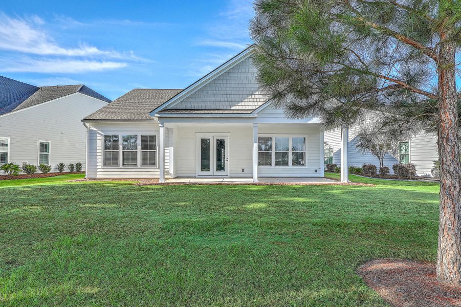 Exterior details and patio area of a home in K. Hovnanian's® Four Seasons at Lakes of Cane Bay, Summerville (Image 23).
