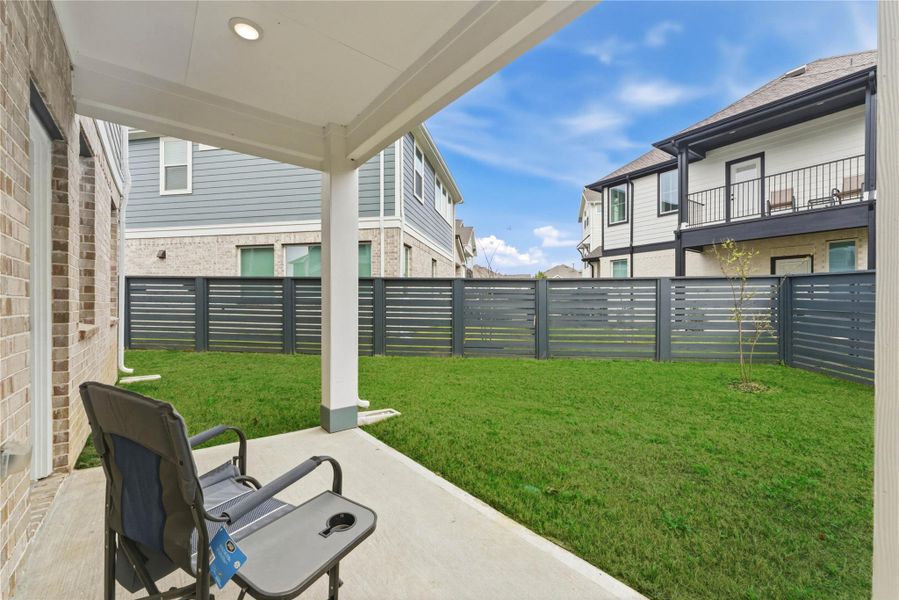 Covered patio provides a shaded outdoor space ideal for grilling, relaxing, or entertaining year-round.