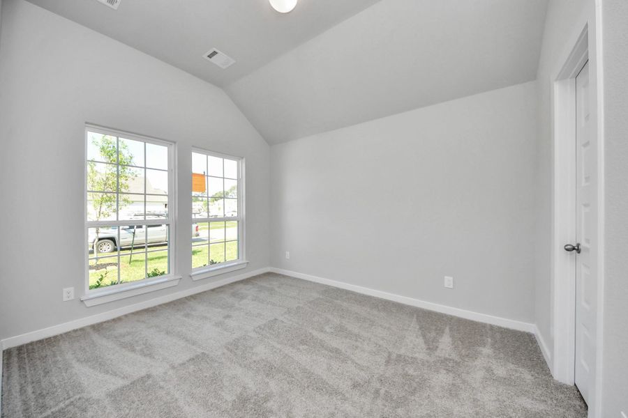 Inviting guest suite adorned with modern charm. The room features elegant 5-panel doors with sleek, contemporary hardware that adds a touch of sophistication. Sink your feet into the plush, fluffy carpet that invites comfort and warmth. Large windows flood the space with an abundance of natural light, framed by privacy blinds that offer the perfect balance between openness and seclusion. Sample photo of completed home with similar floor plan. Actual colors and selections may vary. Inviting guest suite adorned with modern charm. The room features elegant 5-panel doors with sleek, contemporary hardware that adds a touch of sophistication. Sink your feet into the plush, fluffy carpet that invites comfort and warmth. Large windows flood the space with an abundance of natural light, framed by privacy blinds that offer the perfect balance between openness and seclusion. Sample photo of completed home with similar floor plan. Actual colors and selections may vary.