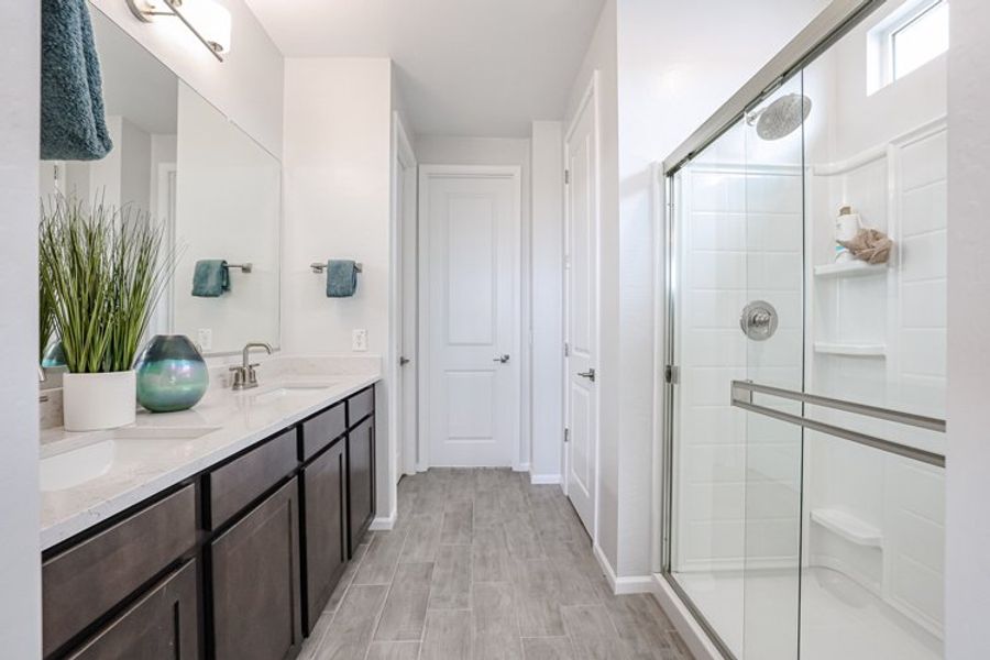 A bathroom with a shower and a glass door. A bathroom with a shower and a glass door.