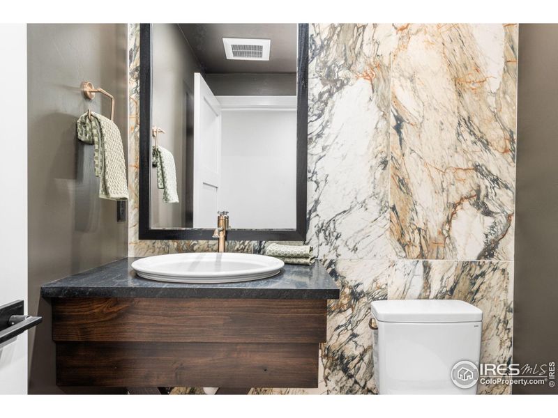 Powder bath in the basement with tiled walls