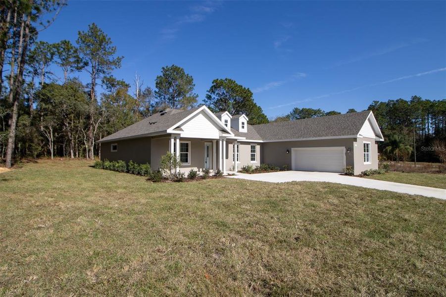 Front exterior of a new home in Pine Ridge Estates, Beverly Hills, FL, highlighting curb appeal (Image 2). Front exterior of a new home in Pine Ridge Estates, Beverly Hills, FL, highlighting curb appeal (Image 2).