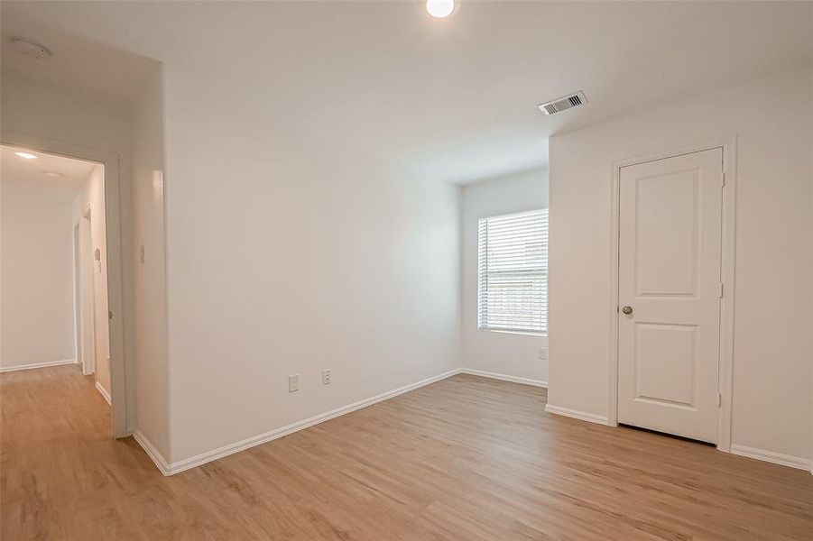 The third guest bedroom is spacious and bright, featuring a sizeable closet, making it a welcoming retreat for guests.