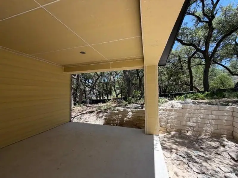 A spacious covered patio offers tranquil outdoor living with a natural, treed backdrop. A spacious covered patio offers tranquil outdoor living with a natural, treed backdrop.