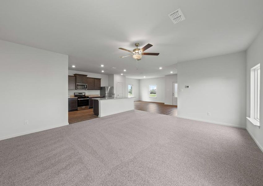 The open-concept layout of this floor plan has the kitchen, family room and dining room sitting next to one another.