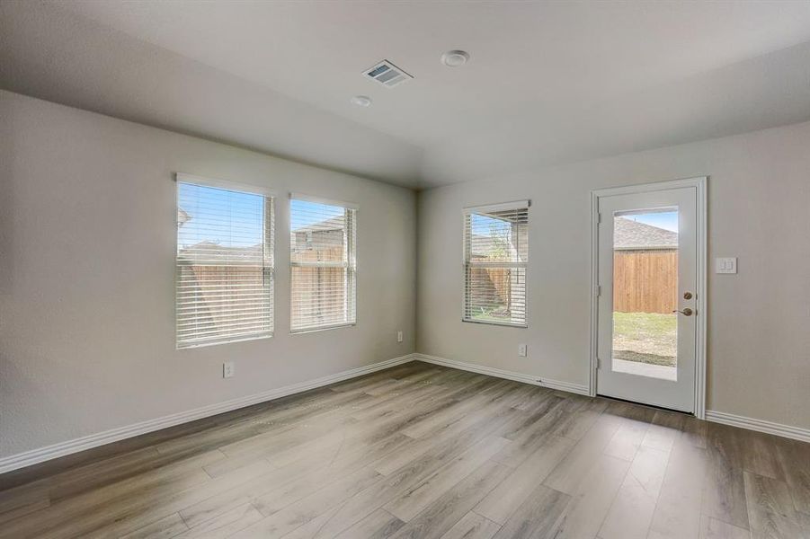 Unfurnished room featuring light hardwood / wood-style floors and plenty of natural light