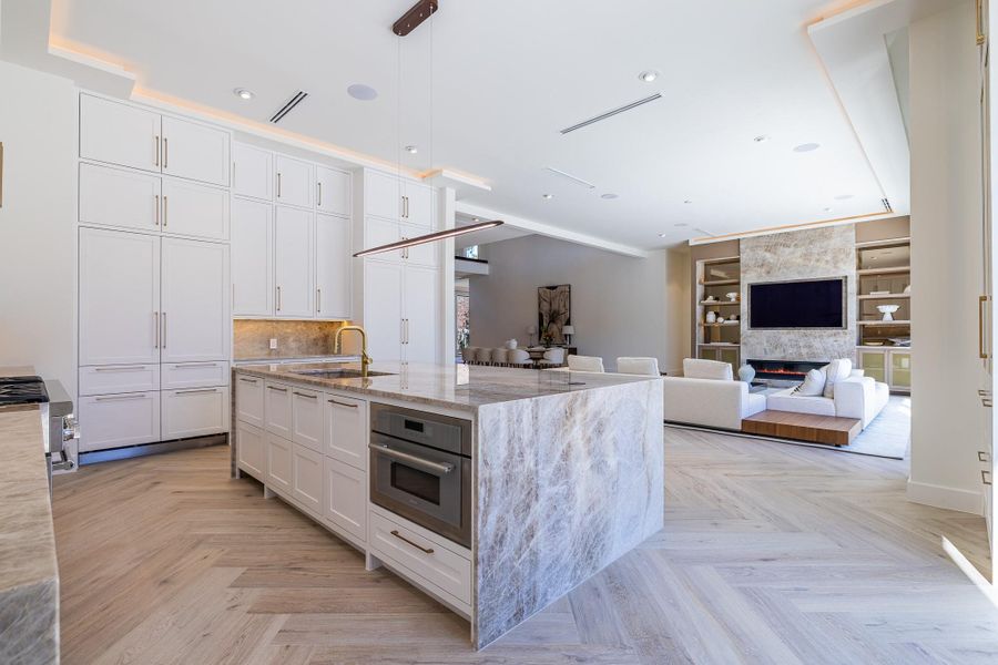 Alternate view of the kitchen island opening to the main living room. Alternate view of the kitchen island opening to the main living room.