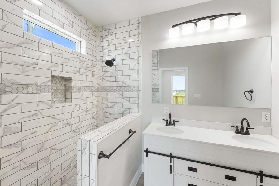 This primary bathroom features a modern design with a spacious walk-in shower, elegant white marble tiles, a double vanity with sleek black fixtures, and ample natural light from a high window. This primary bathroom features a modern design with a spacious walk-in shower, elegant white marble tiles, a double vanity with sleek black fixtures, and ample natural light from a high window.