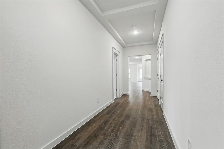 Hall featuring dark wood-style floors and baseboards Hall featuring dark wood-style floors and baseboards