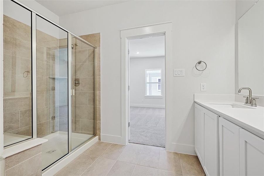 Bathroom with tile patterned floors, walk in shower, and vanity Bathroom with tile patterned floors, walk in shower, and vanity