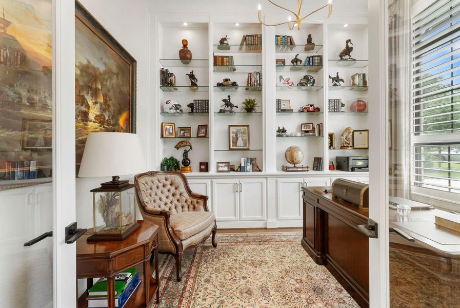 A dedicated study with custom built-ins provides a polished work-from-home setting. Plantation shutters, custom window coverings, and added lighting details support privacy and focus.