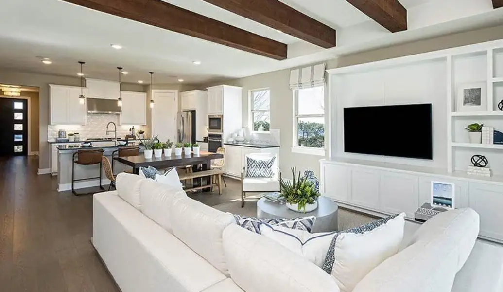 Living area featuring recessed lighting, beam ceiling, and dark wood-style floors Living area featuring recessed lighting, beam ceiling, and dark wood-style floors