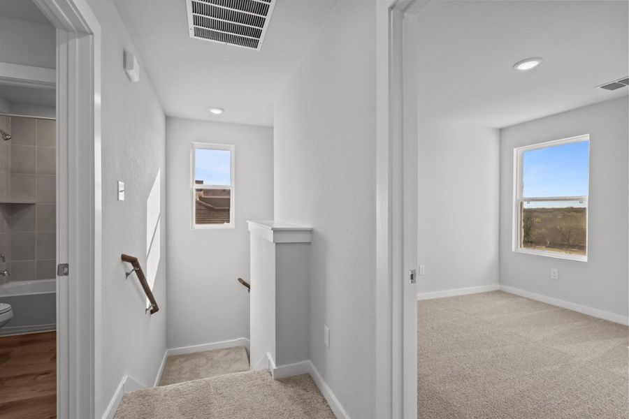 A bathroom with a tub and toilet.