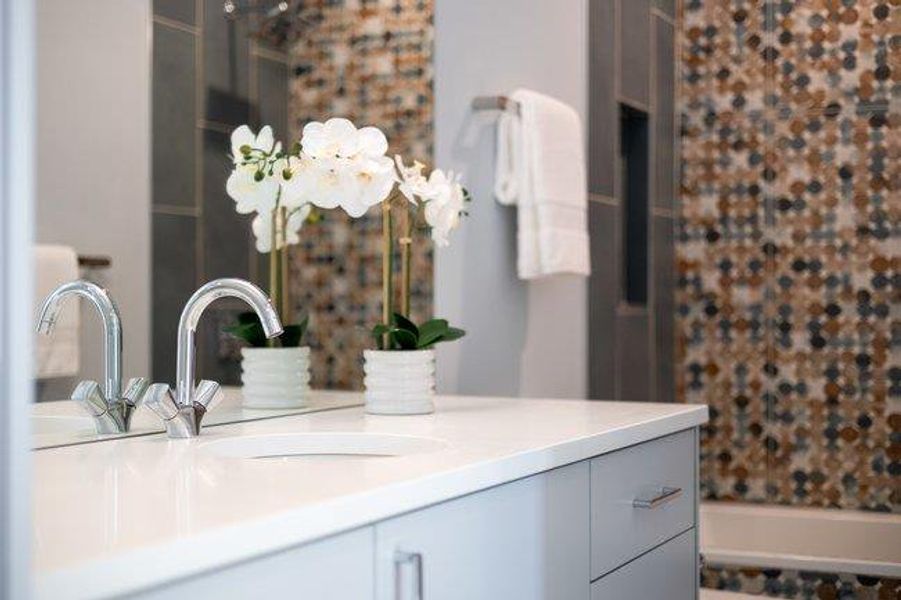 Full bathroom featuring custom tile and full bath.