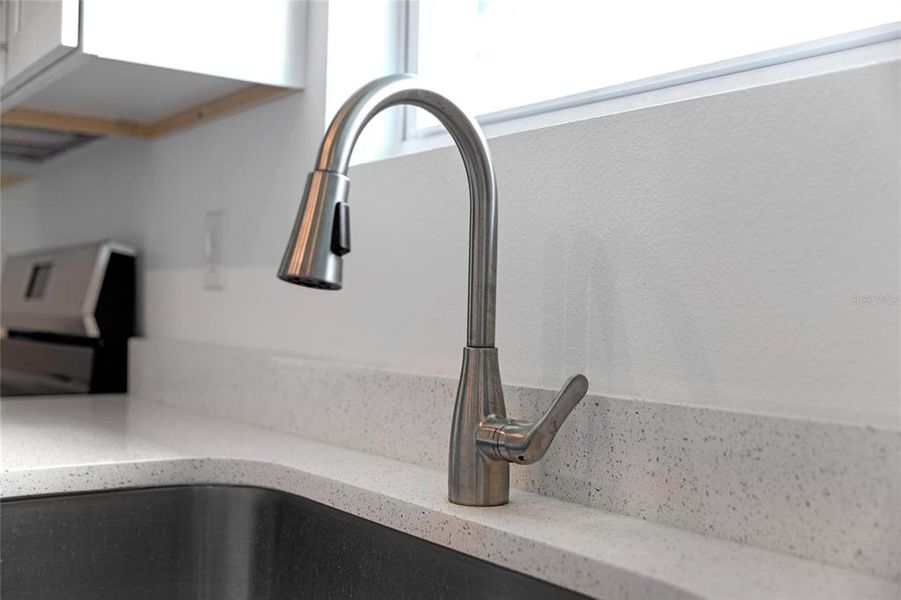 Large kitchen sink with window view * granite countertops.