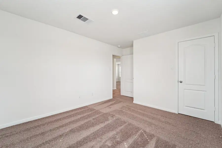 Secondary bedroom view into hallway.