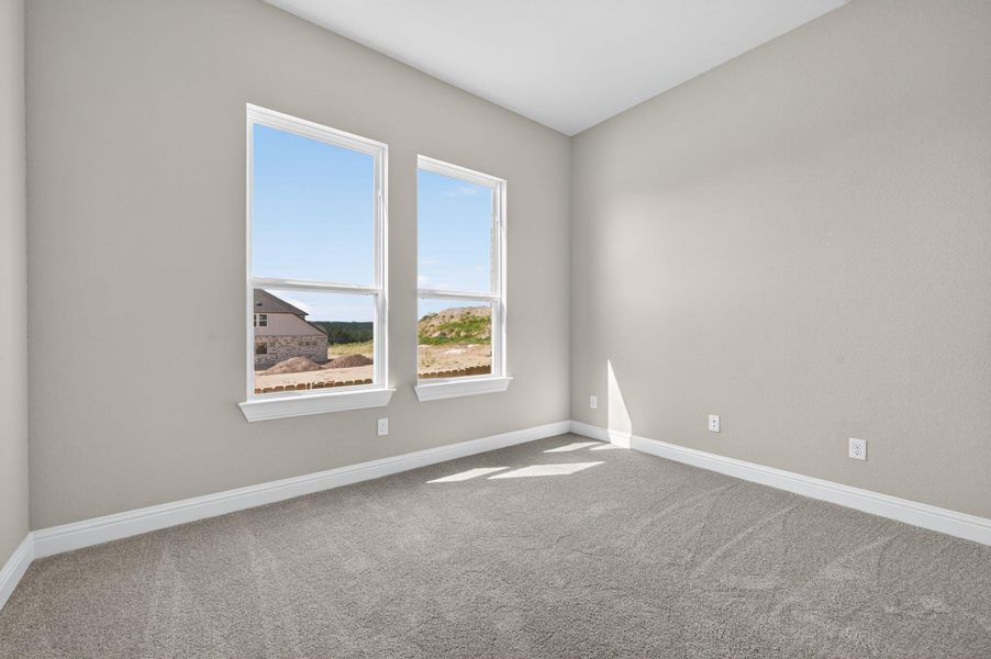 Unfurnished room featuring carpet floors and baseboards
