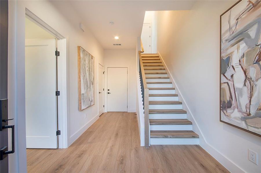 Stairway with wood finished floors and recessed lighting Stairway with wood finished floors and recessed lighting