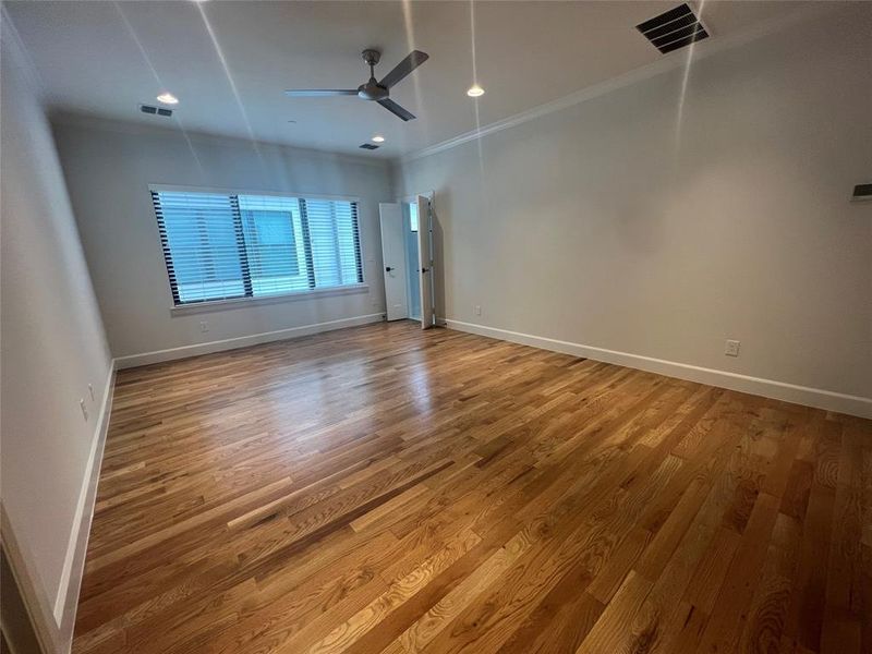 Spare room featuring ornamental molding, wood-type flooring, and ceiling fan