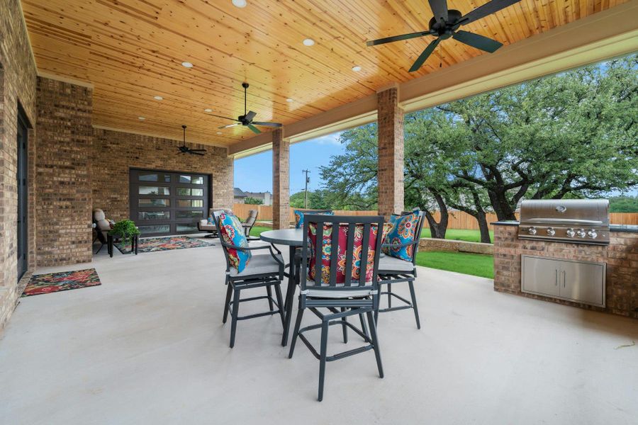 Covered patio featuring a wood-finish ceiling with recessed lighting and ceiling fans