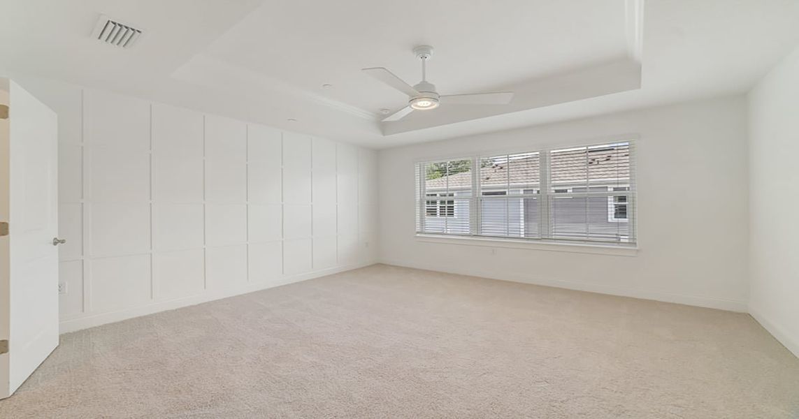 Primary suite with decorated feature wall & tray ceiling Primary suite with decorated feature wall & tray ceiling