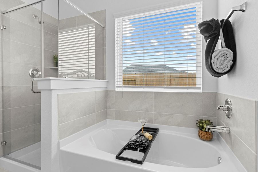The luxurious soaking tub is framed by large windows and neutral tile surround, offering a relaxing retreat bathed in natural light—perfect for unwinding after a long day. The luxurious soaking tub is framed by large windows and neutral tile surround, offering a relaxing retreat bathed in natural light—perfect for unwinding after a long day.