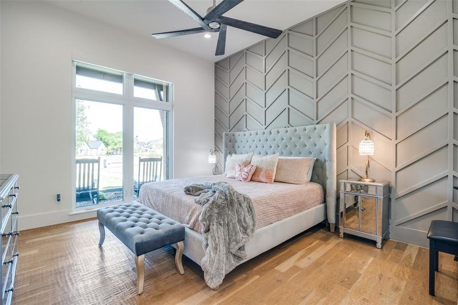 Bedroom featuring light hardwood / wood-style floors, access to outside, and ceiling fan