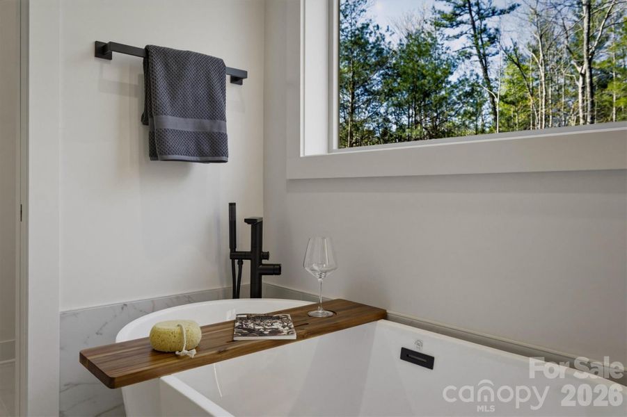 Perhaps the most extravagant piece in the bathroom is this freestanding 5' tub under a huge window, and there is even a freestanding tub filler. It will be the perfect spot to relax. Perhaps the most extravagant piece in the bathroom is this freestanding 5' tub under a huge window, and there is even a freestanding tub filler. It will be the perfect spot to relax.