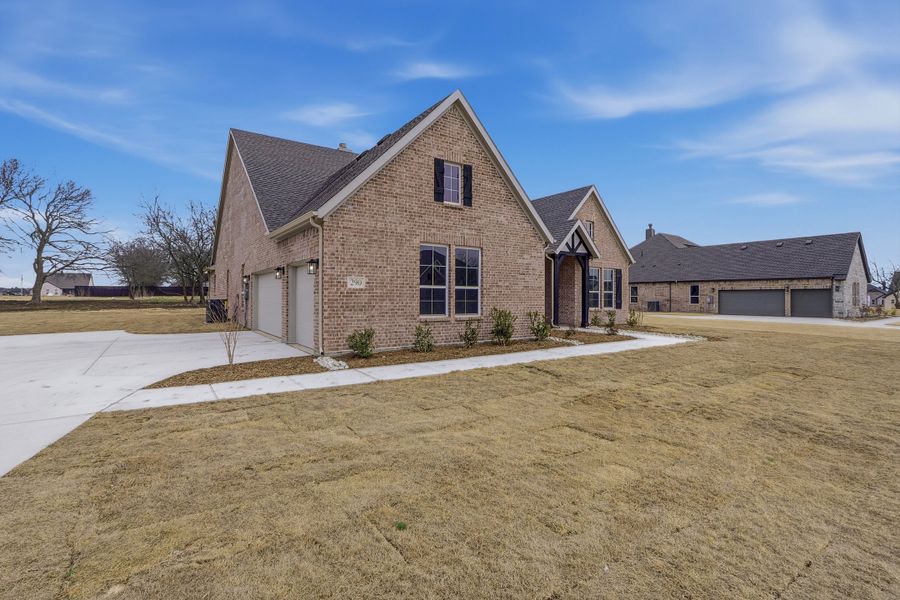 Front exterior of a new home in Fannin Ranch, Leonard, TX, highlighting curb appeal (Image 21). Front exterior of a new home in Fannin Ranch, Leonard, TX, highlighting curb appeal (Image 21).