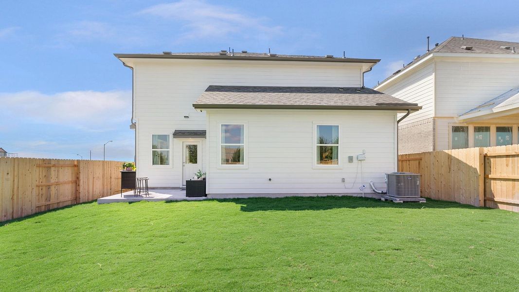 A spacious backyard with vibrant green grass offers a welcoming outdoor living area. A spacious backyard with vibrant green grass offers a welcoming outdoor living area.