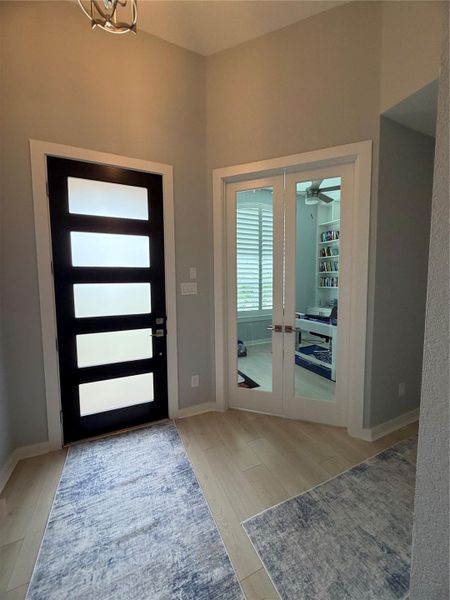 front entry with double doors to office with custom shelving front entry with double doors to office with custom shelving