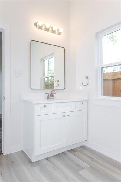 Bathroom with wood-type flooring and vanity