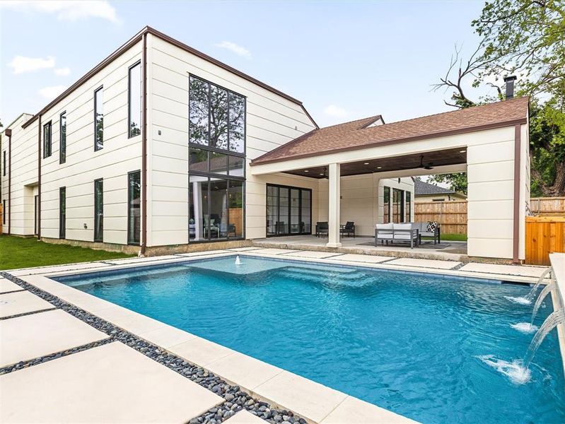 View of swimming pool with a patio and pool water feature