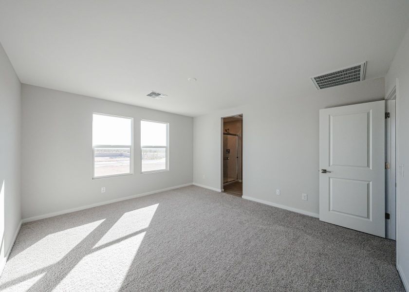 A room with white walls and a door.