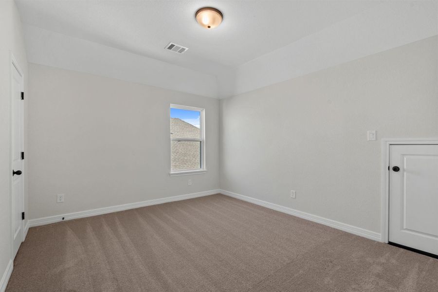 Your secondary bedroom features plush carpet, fresh paint, closet, and a large window that lets in plenty of natural lighting.