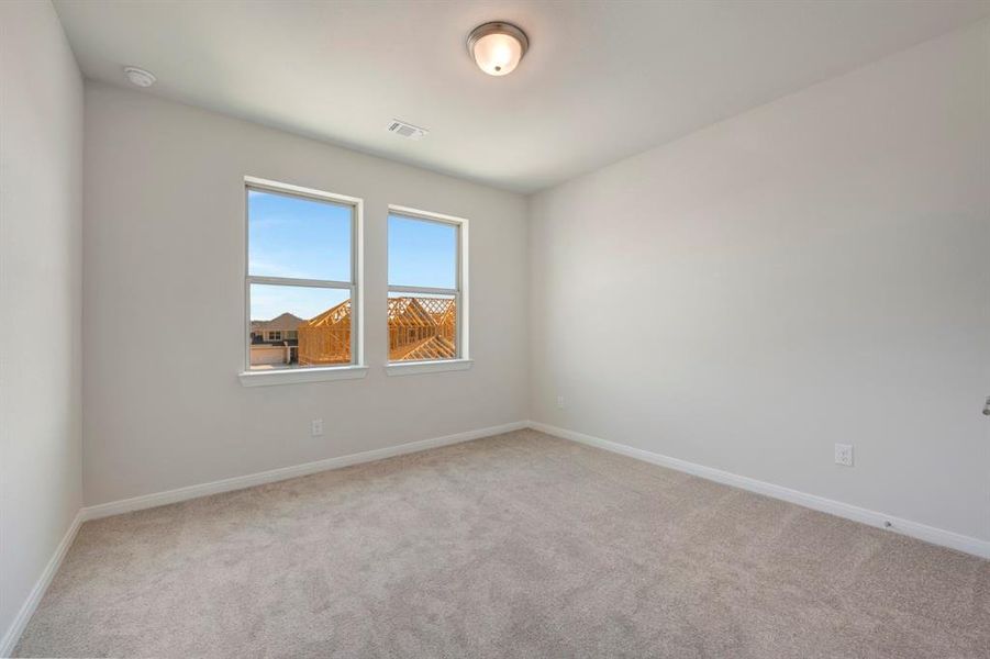 Unfurnished room with light colored carpet and baseboards