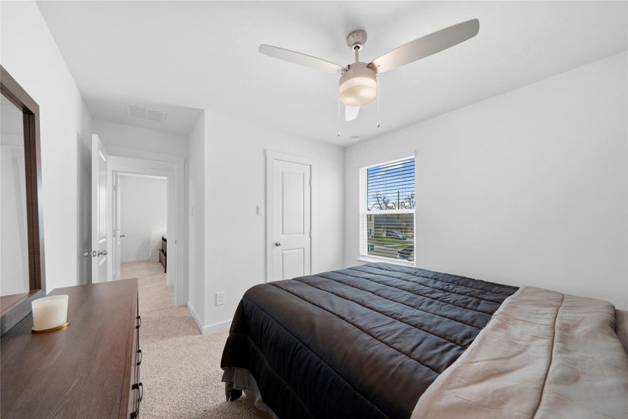 From this angle, the third bedroom showcases a refined, neutral palette and a ceiling fan, offering a calm and inviting atmosphere. From this angle, the third bedroom showcases a refined, neutral palette and a ceiling fan, offering a calm and inviting atmosphere.