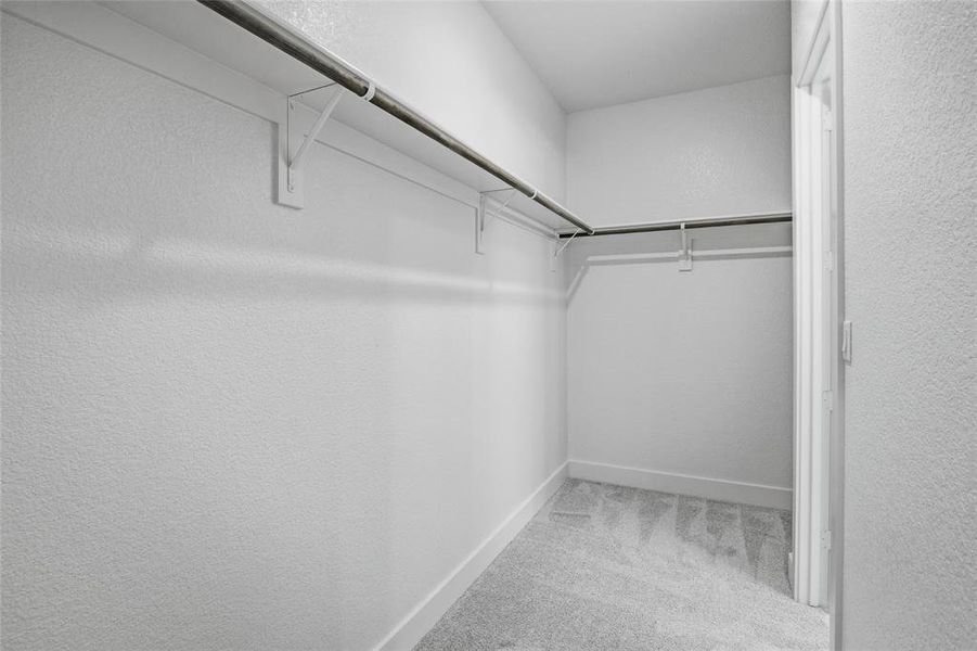 Walk in closet featuring light carpet