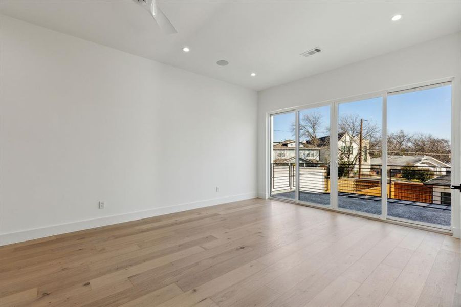 Unfurnished room with ceiling fan and light hardwood / wood-style floors