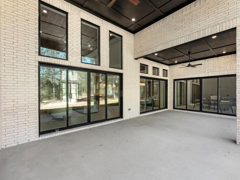 Seamless indoor-outdoor living extends to a covered patio, perfect for relaxing, dining, or entertaining while enjoying peaceful views of the property.