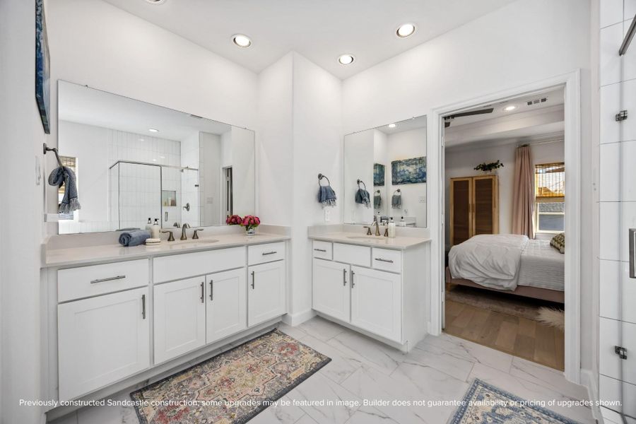 Two vanities, sleek quartz counters, and plenty of storage make mornings smoother and evenings more serene.