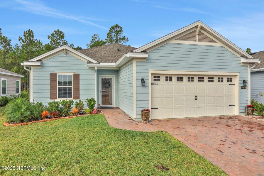 Exterior details and patio area of a home in Tributary: Lakeview at Tributary 50's, Yulee (Image 1).