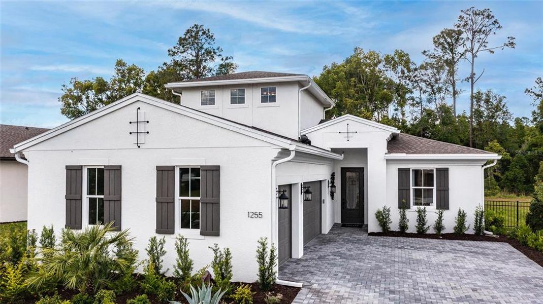 Front exterior of a new home in Cresswind DeLand, Deland, FL, highlighting curb appeal (Image 21). Front exterior of a new home in Cresswind DeLand, Deland, FL, highlighting curb appeal (Image 21).