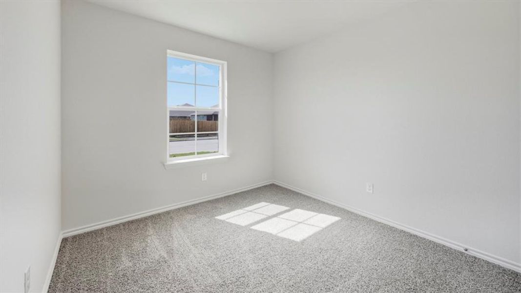 Unfurnished room with light carpet and baseboards Unfurnished room with light carpet and baseboards