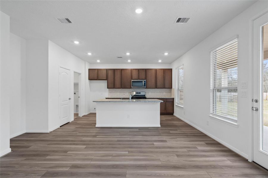 Create lasting memories around the table with family and friends in this inviting dining room! It showcases high ceilings, large windows with privacy blinds, and recessed lighting, and access door to the back patio and yard.