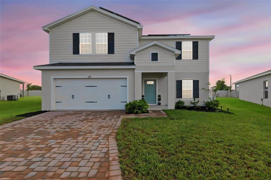Front exterior of a new home in , Haines City, FL, highlighting curb appeal (Image 1). Front exterior of a new home in , Haines City, FL, highlighting curb appeal (Image 1).