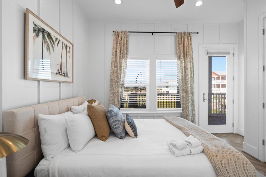 This luminous secondary bedroom offers a calm, curated escape. A neutral palette sets the tone for effortless style, while a window reveals a glimpse of the shared balcony—also accessible through its own private door. Thoughtful touches like the soft bedside lighting and warm ceiling fan elevate the space into a blend of comfort and coastal elegance. This luminous secondary bedroom offers a calm, curated escape. A neutral palette sets the tone for effortless style, while a window reveals a glimpse of the shared balcony—also accessible through its own private door. Thoughtful touches like the soft bedside lighting and warm ceiling fan elevate the space into a blend of comfort and coastal elegance.