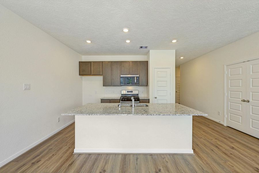The added breakfast bar adds additional seating and a gathering point for family and friends.